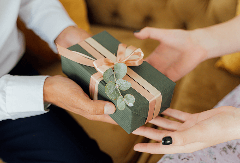 Man presenting gift to a woman