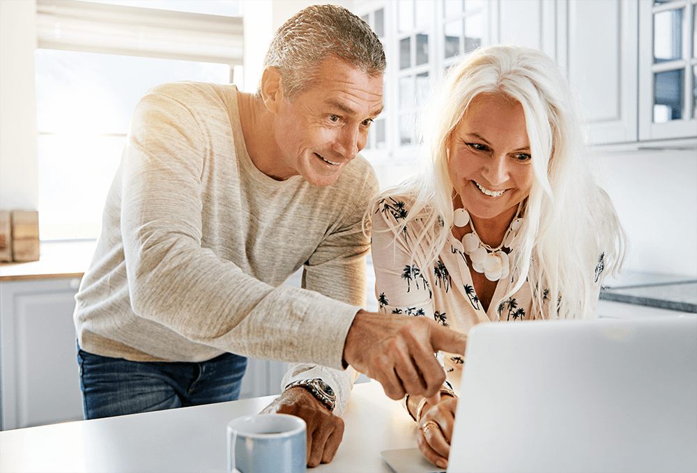 Happy couple looking at computer