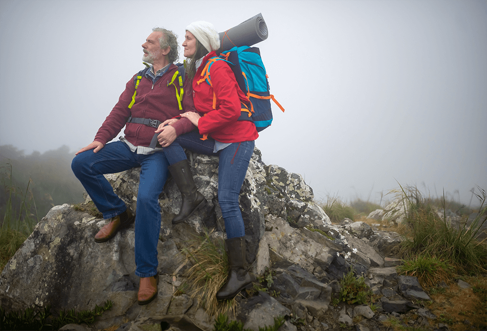 Couple backpackers hiking in mountains